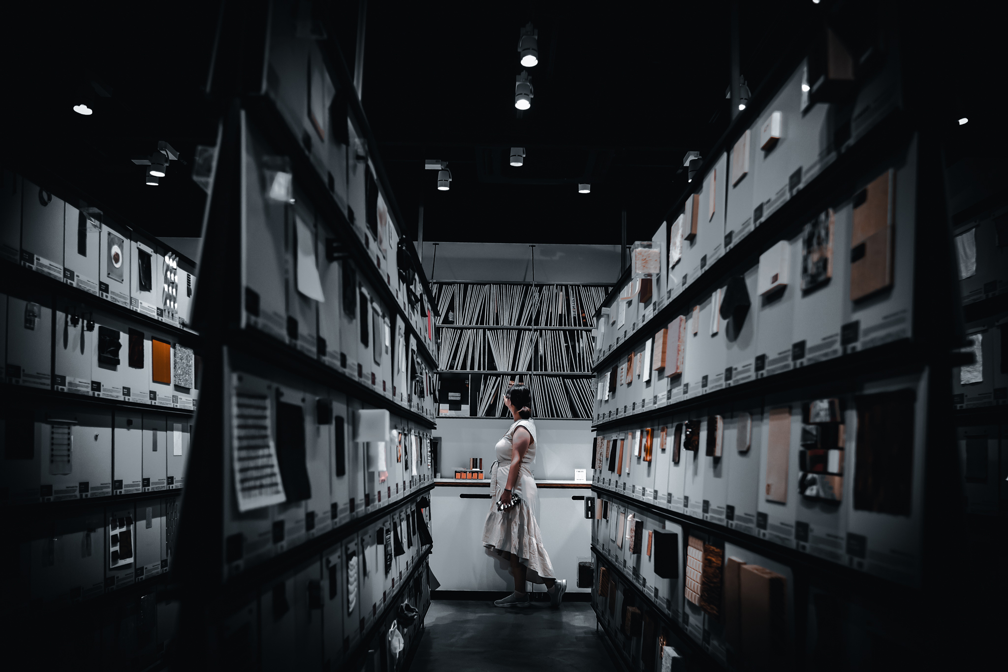 A student walks through a gallery of an assortment of materials for inspiration on an upcoming project.