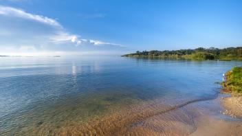 A photo of a river. Blue skies in the background.