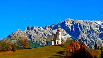 Photo of a building nestled in the mountains.