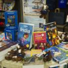 A table full of travel books, Gunrock keychains and globes