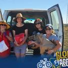 Five people pose with bags of produce in front of a white van in a rural setting. UC Davis Global Affairs and "#GlobalAggies" are displayed in the foreground.