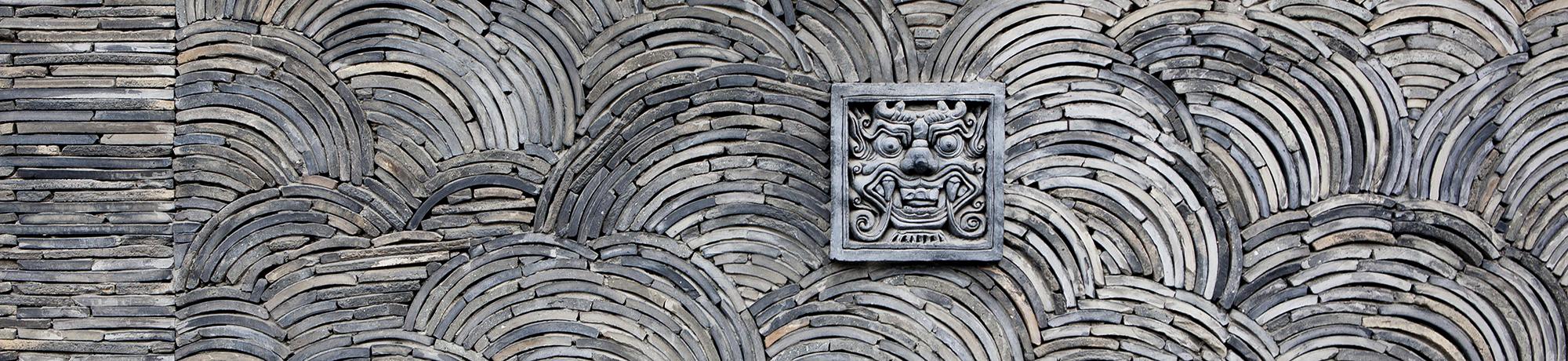 photo of a wall with a spiral design and a section of the wall with an artistic frame